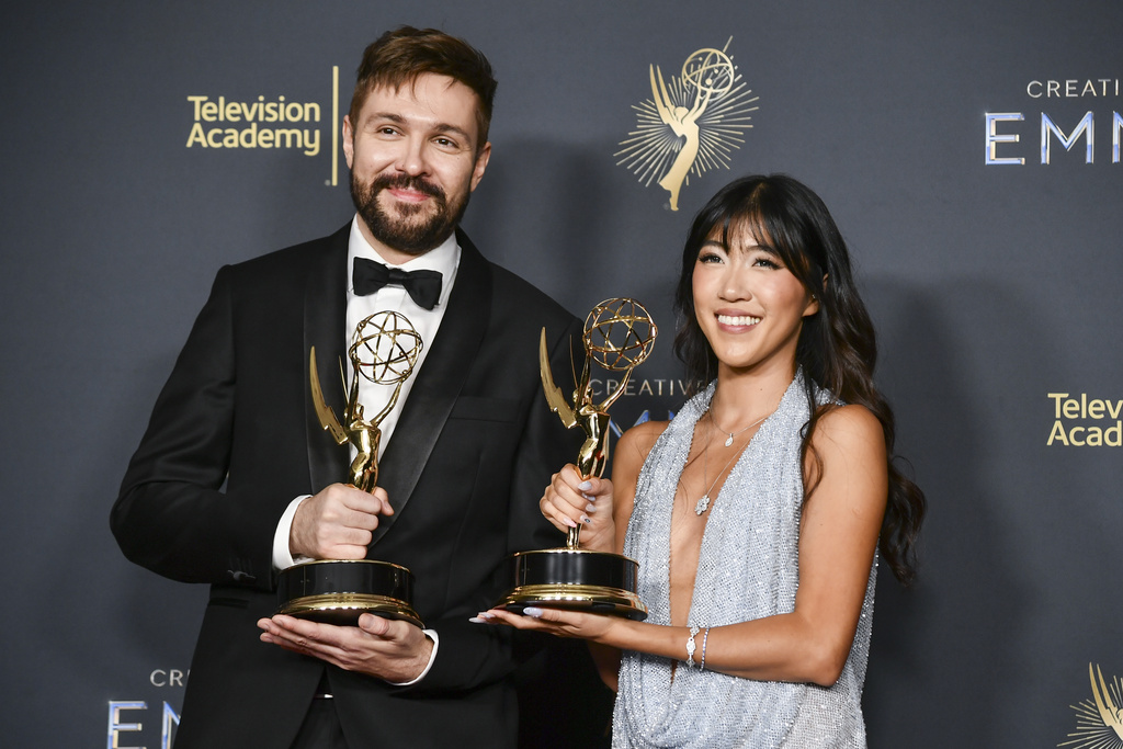Maciej Kuciara, left, and Emily Yang pose in the press room with the award for outstanding innovation in emerging media programming for "White Rabbit" during night two of the Creative Arts Emmy Awards on Sunday, Sept. 7, 2025, at the Peacock Theater in Los Angeles. (Photo by Richard Shotwell/Invision/AP)