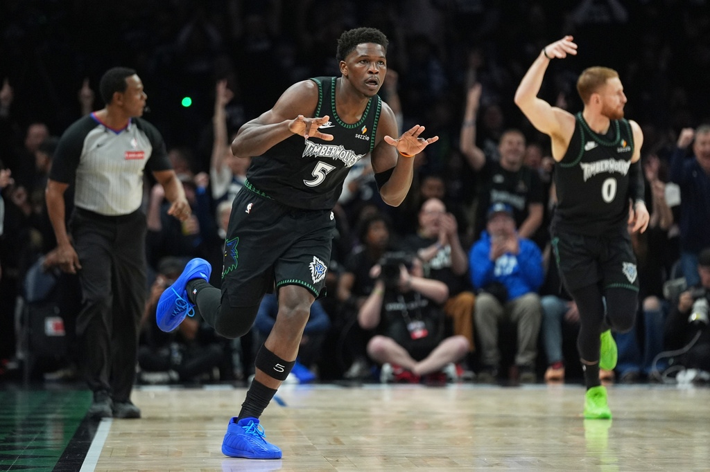 Minnesota Timberwolves guard Anthony Edwards (5) celebrates after making a 3-point shot during the first half of Game 4 of a first-round NBA basketball playoff series against the Denver Nuggets, Saturday, April 25, 2026, in Minneapolis. (AP Photo/Abbie Parr)