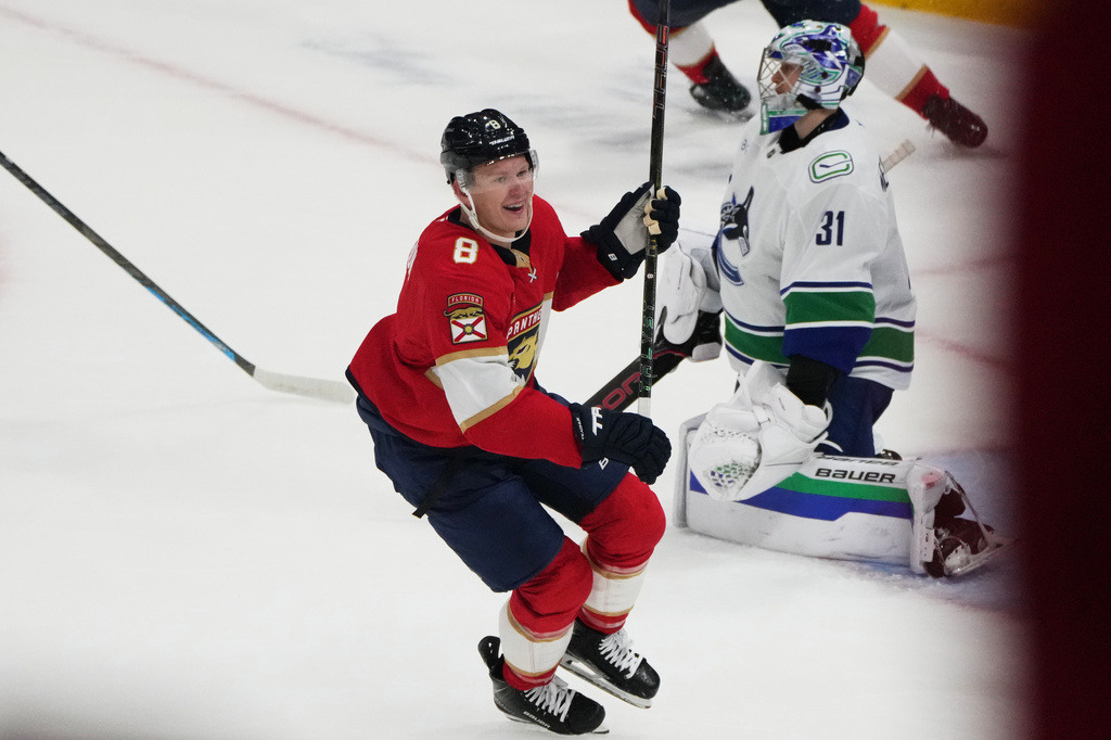 Florida Panthers left wing Brady Tkachuk (8) celebrates after scoring the game winning goal against Vancouver Canucks goaltender Leevi Meril&auml;inen (31) during overtime in an NHL hockey game, Thursday, Oct. 15, 2026, in Sunrise, Fla. (AP Photo/Lynne Sladky)
