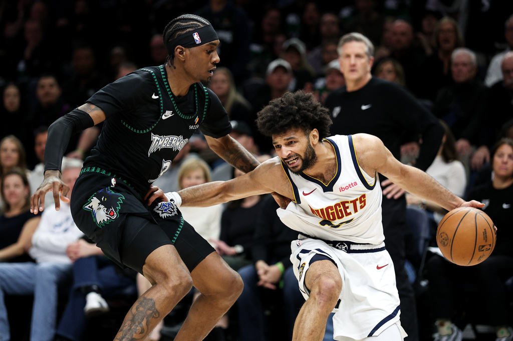 Denver Nuggets guard Jamal Murray, right, controls the ball as Minnesota Timberwolves forward Jaden McDaniels, left, defends during the first half of Game 6 of a first-round NBA basketball playoffs series, Thursday, April 30, 2026, in Minneapolis. (AP Photo/Matt Krohn)