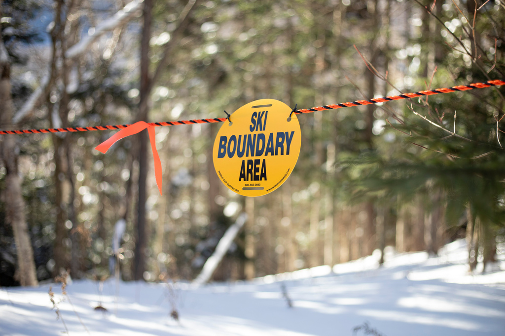 A ski boundary sign is posted on the Toll Road trail at Stowe Mountain Resort on Friday, Dec. 5, 2025 in Stowe, Vt. (AP Photo/Amanda Swinhart)