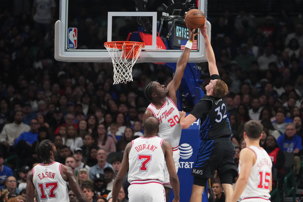 Houston Rockets center Clint Capela (30) blocks a shot by Dallas Mavericks forward Cooper Flagg (32) during the first half of an NBA basketball game Saturday, Jan. 3, 2026, in Dallas. (AP Photo/Julio Cortez)