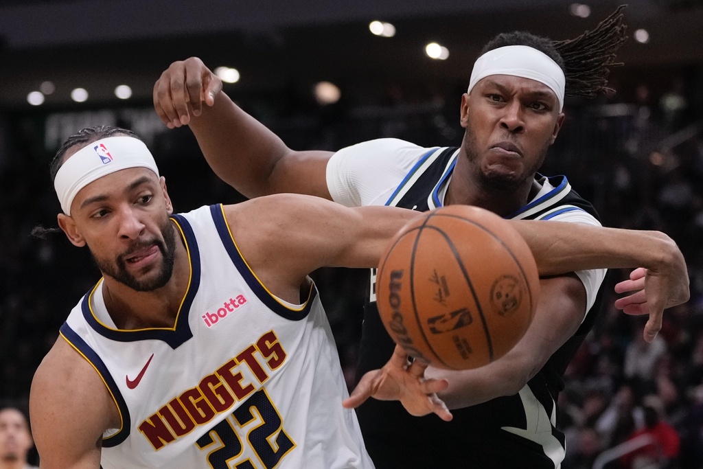 Milwaukee Bucks' Myles Turner and Denver Nuggets' Zeke Nnaji go after a loose ball during the first half of an NBA basketball game Friday, Jan. 23, 2026, in Milwaukee. (AP Photo/Morry Gash)