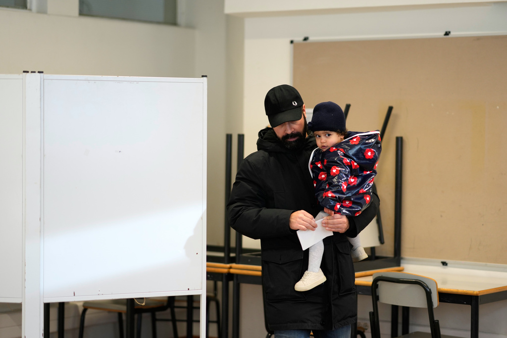 A man folds his ballot as he votes in Portugal's presidential election at a polling station in Lisbon, Sunday, Jan. 18, 2026. (AP Photo/Armando Franca)
