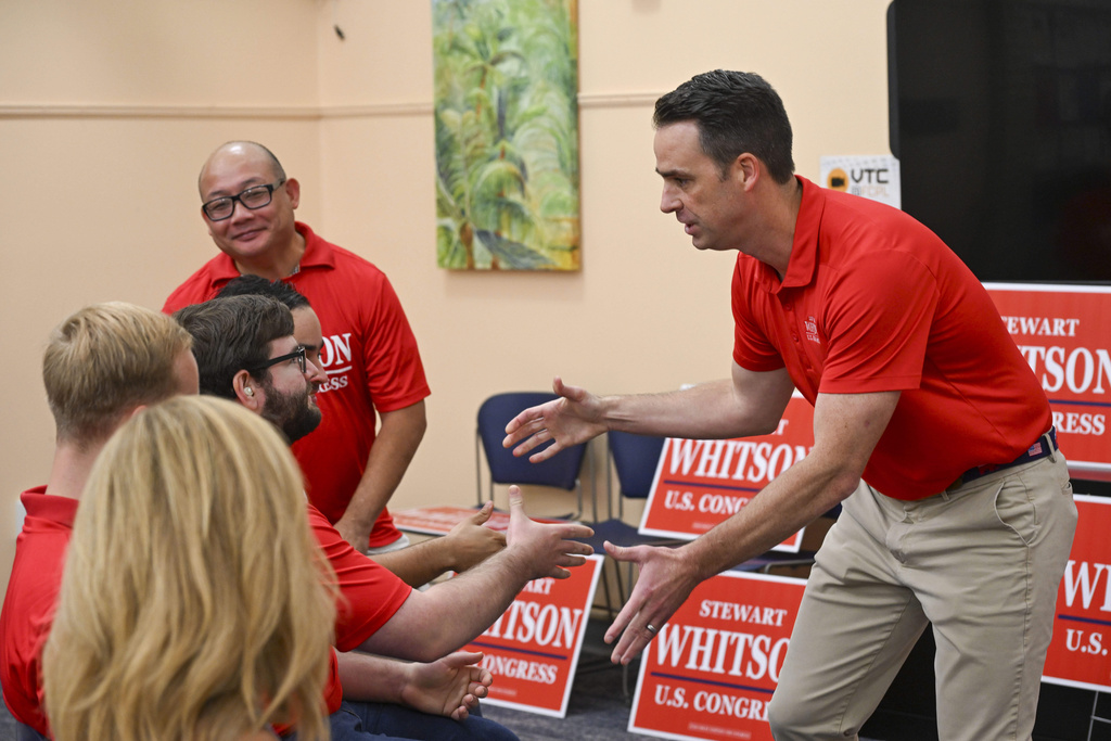 Republican candidate Stewart Whitson, left, who is running for the empty 11th congressional seat, thanks supporters at a rally in the Kings Park Library, Saturday, Sept. 6, 2025 in Burke, Va. (AP Photo/Kevin Wolf)