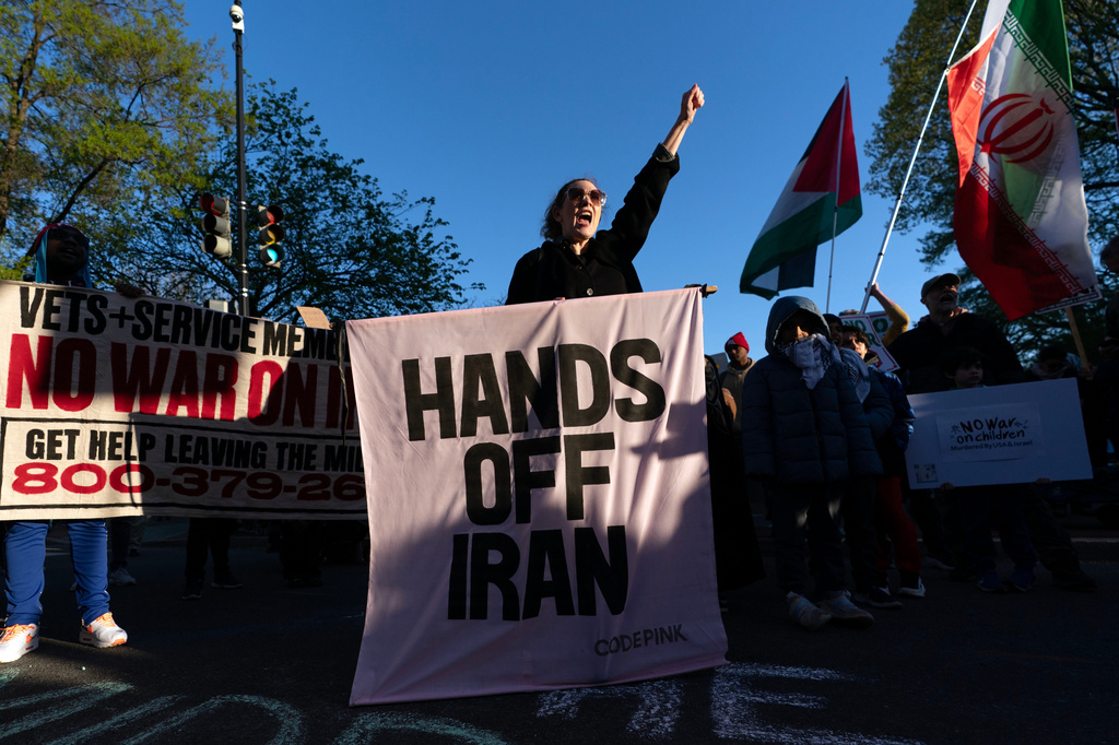 Activists protest near the White House in Washington, Tuesday evening, April 7, 2026. (AP Photo/Jose Luis Magana)