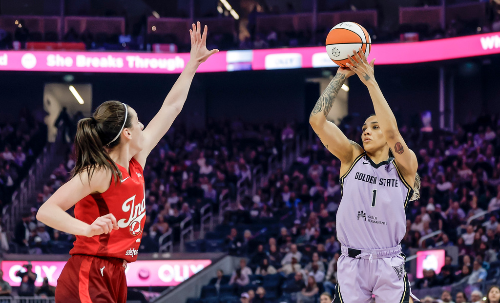 Golden State Valkyries' Gabby Williams (1) shoots a 3-point shot over Indiana Fevers' Caitlin Clark (22) during the first half of a WNBA basketball game in San Francisco on Thursday, May 28, 2026. (Carlos Avila Gonzalez/San Francisco Chronicle via AP)