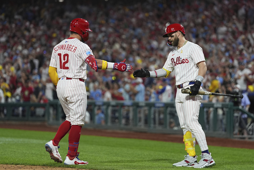Philadelphia Phillies' Kyle Schwarber, left, celebrates with Bryce Harper after hitting a home run off of Angel Zerpa during the fifth inning of a baseball game, Saturday, Sept. 13, 2025, in Philadelphia. (AP Photo/Matt Rourke)