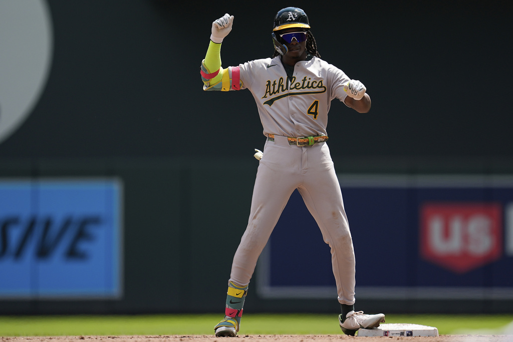 Athletics' Lawrence Butler (4) celebrates after hitting a three-run double during the second inning of a baseball game against the Minnesota Twins, Thursday, Aug. 21, 2025, in Minneapolis. (AP Photo/Abbie Parr)