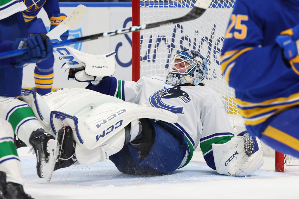 Vancouver Canucks goaltender Thatcher Demko (35) looks for the puck in traffic during the first period of an NHL hockey game against the Buffalo Sabres Tuesday, Jan. 6, 2026, in Buffalo, N.Y. (AP Photo/Jeffrey T. Barnes)