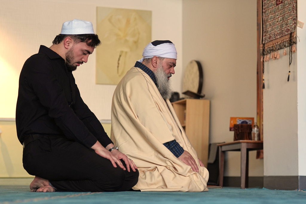 Celal Emanet, right, and his son Muhammed Emanet pray in a back room of the family's restaurant Jersey Kebab, Thursday, Jan. 29, 2026, in Collingswood, N.J. (AP Photo/Matt Rourke)