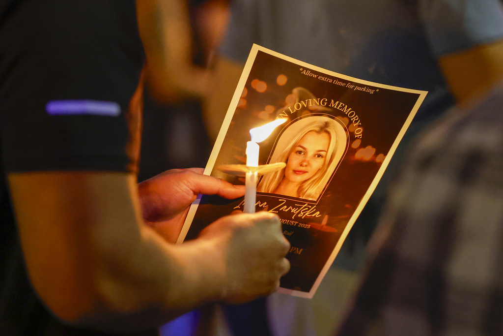 Community members gather for a vigil honoring the life of Iryna Zarutska, who was fatally stabbed on a commuter train last month, Monday, Sept. 22, 2025, in Charlotte, N.C. (AP Photo/Nell Redmond)