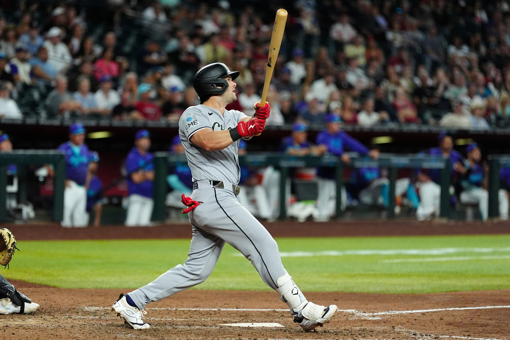 Chicago White Sox's Andrew Benintendi watches the flight of his three-run home run against the Arizona Diamondbacks during the ninth inning of a baseball game, Thursday, April 23, 2026, in Phoenix. (AP Photo/Ross D. Franklin)