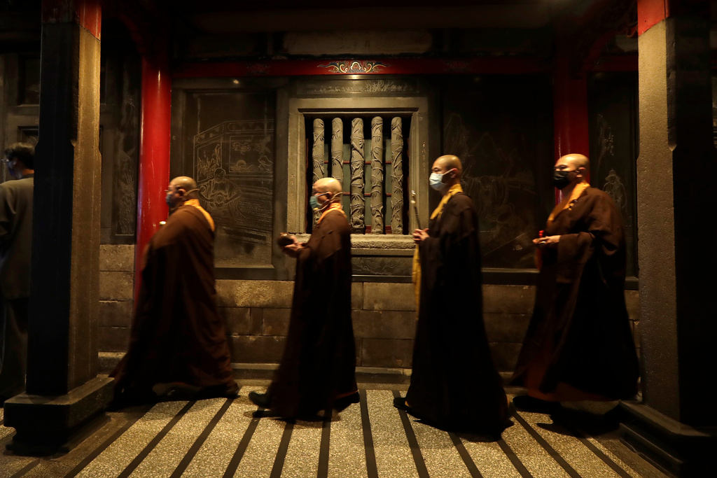 Monks pray on the eve of the Lunar New Year celebrations in Taipei, Taiwan, Monday, Feb. 16, 2026. (AP Photo/Chiang Ying-ying)