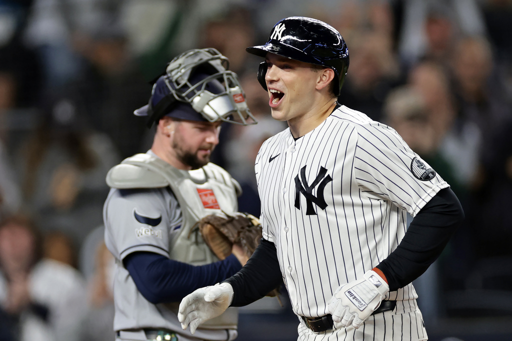 New York Yankees' Ben Rice reacts after hitting a solo home run in front of Tampa Bay Rays catcher Liam Hicks during the first inning of a baseball game Wednesday, Sept. 23, 2026, in New York. (AP Photo/Adam Hunger)