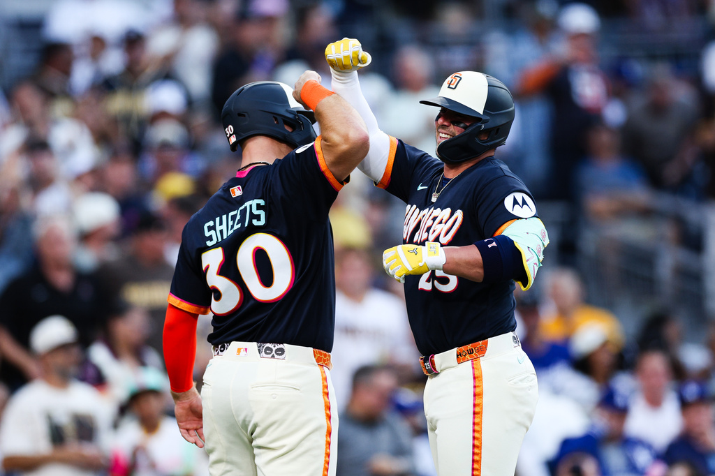 San Diego Padres' Ty France, right, celebrates with Gavin Sheets after hitting a three-run home run against the Los Angeles Dodgers in the second inning of a baseball game, Friday, June 26, 2026, in San Diego. (AP Photo/Derrick Tuskan)