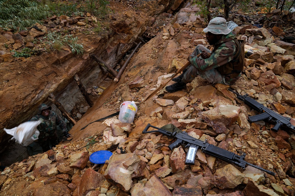 South African National Defense Force soldiers retrieve clothing and food stock left by illegal miners, in Randfontein, in Johannesburg, South Africa, Thursday, March 12, 2026. (AP Photo/Themba Hadebe)