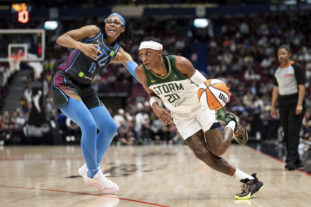 Seattle Storm's Brittney Sykes (20) drives past Atlanta Dream's Allisha Gray (15) during the first half of a WNBA basketball game in Vancouver, British Columbia, on Friday, Aug. 15, 2025. (Ethan Cairns/The Canadian Press via AP)