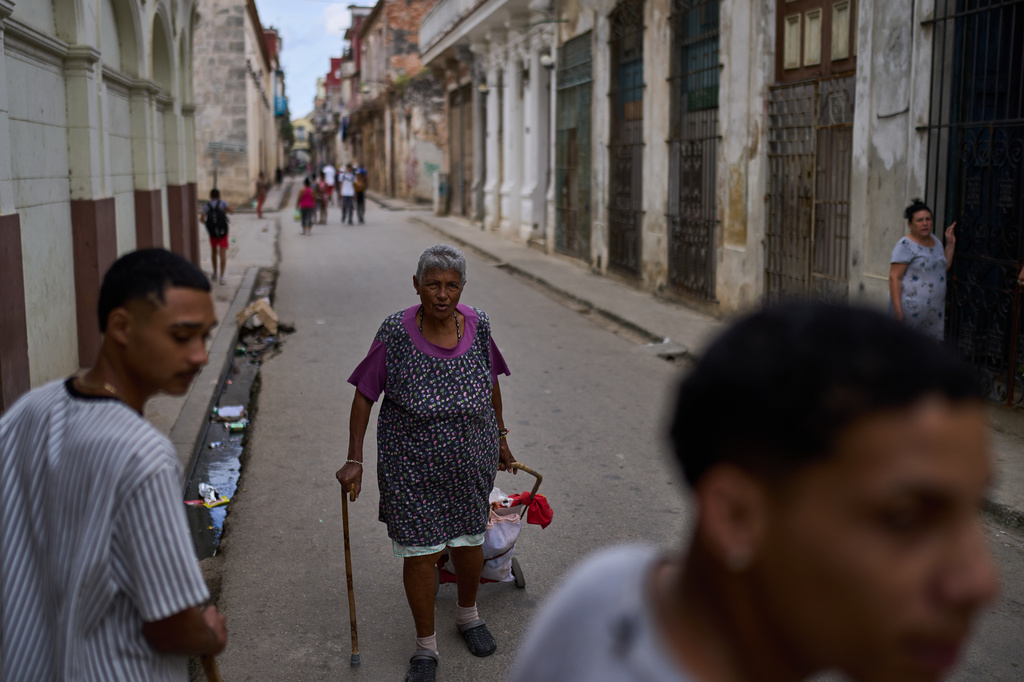 Iris Cecilia Ramirez runs errands in Old Havana, Cuba, Saturday, Feb. 15, 2025. (AP Photo/Ramon Espinosa)