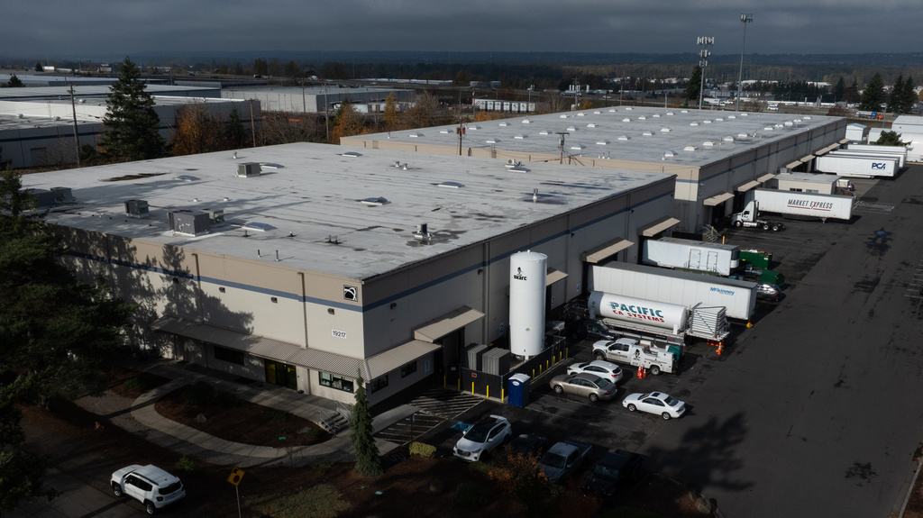 Vehicles are seen at a building that houses ByHeart, a manufacturer of organic baby formula, plant on Tuesday, Nov. 11, 2025, in Portland, Ore. (AP Photo/Jenny Kane)