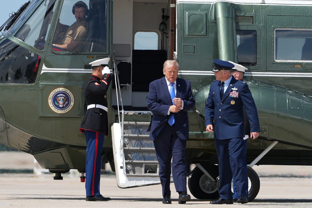 President Donald Trump walks from Marine One with Air Force Col. Christopher M. Robinson, commander of the 89th Airlift Wing, to board Air Force One, Tuesday, Aug. 4, 2026, at Joint Base Andrews, Md. (AP Photo/Mark Schiefelbein)