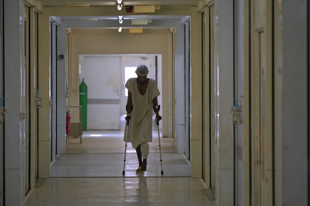 FILE - A gunshot victim recovering from injuries walks through a Doctors Without Borders clinic in Port-au-Prince, Haiti, May 15, 2026. (AP Photo/Odelyn Joseph, File)