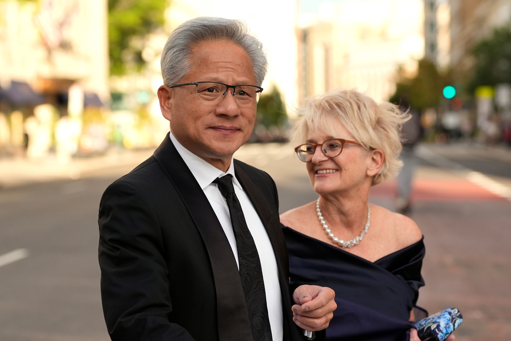 Nvidia CEO Jensen Huang, left, and his wife Lori Huang walk to the White House to attend a state dinner hosted for China's President Xi Jinping, Thursday, Sept. 24, 2026, in Washington. (AP Photo/Carolyn Kaster)