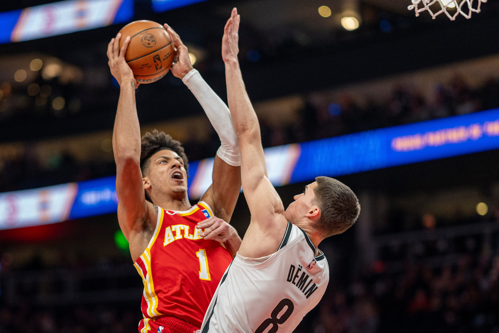 Atlanta Hawks forward Jalen Johnson (1) attempts a basket against Brooklyn Nets guard Egor Dëmin (8) during the first half of an NBA basketball game, Sunday, Feb. 22, 2026, in Atlanta. (AP Photo/Erik Rank)