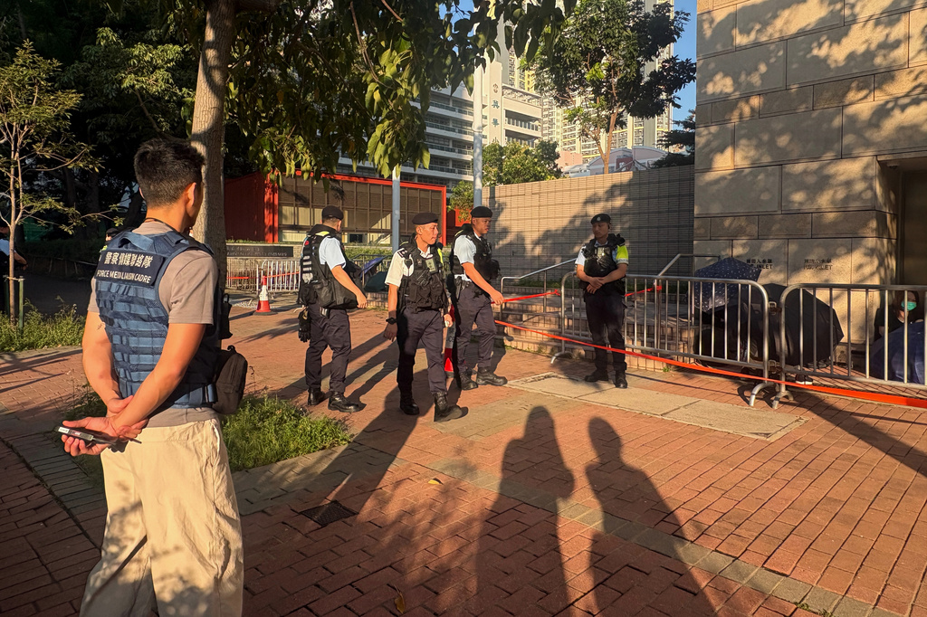 Police officers deploy outside the West Kowloon Magistrates' Courts in Hong Kong on Friday, Sept. 11, 2026, ahead of sentencing for former Tiananmen vigil organizers. (AP Photo/Kanis Leung)
