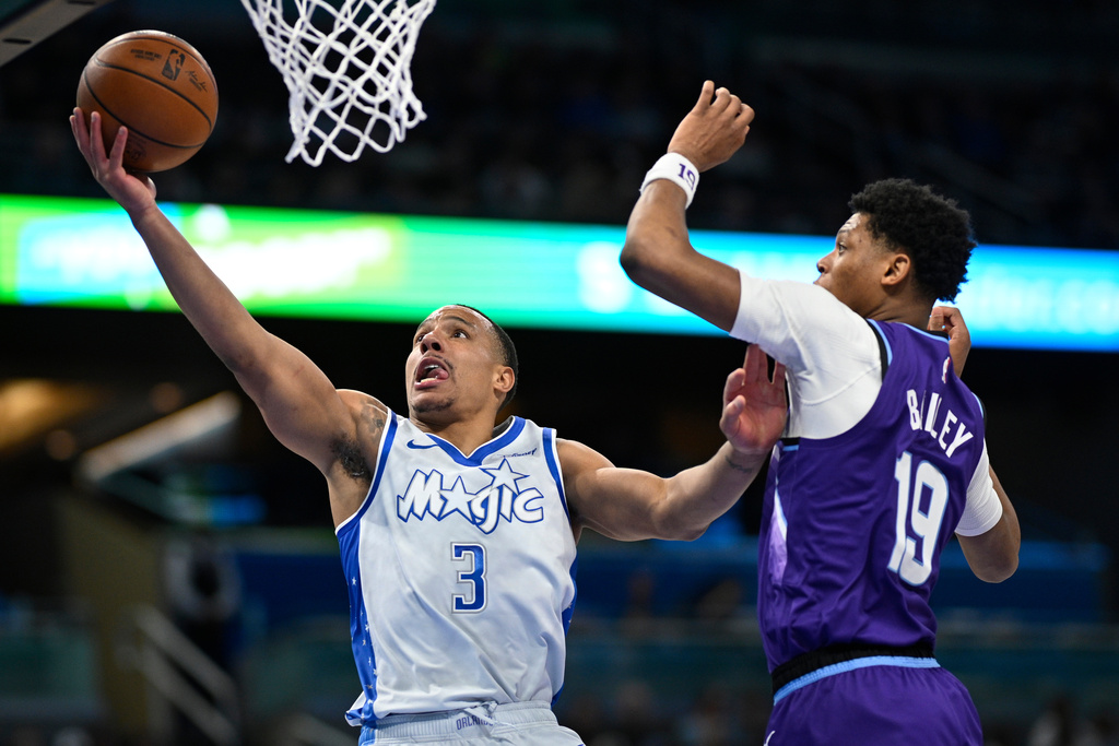 Orlando Magic guard Desmond Bane (3) goes up to shoot as Utah Jazz guard Ace Bailey (19) defends during the first half of an NBA basketball game, Saturday, Feb. 7, 2026, in Orlando, Fla. (AP Photo/Phelan M. Ebenhack)