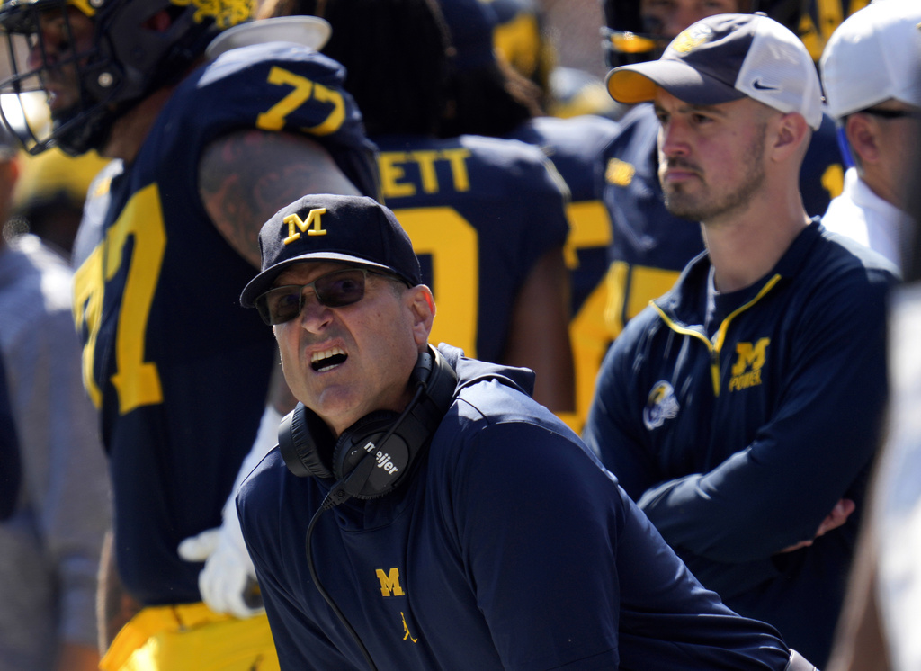 FILE - Michigan head coach Jim Harbaugh, front left, watches against Rutgers as analytics assistant Connor Stalions, right, looks on during an NCAA college football game in Ann Arbor, Mich., Sept. 23, 2023. (AP Photo/Paul Sancya, File)