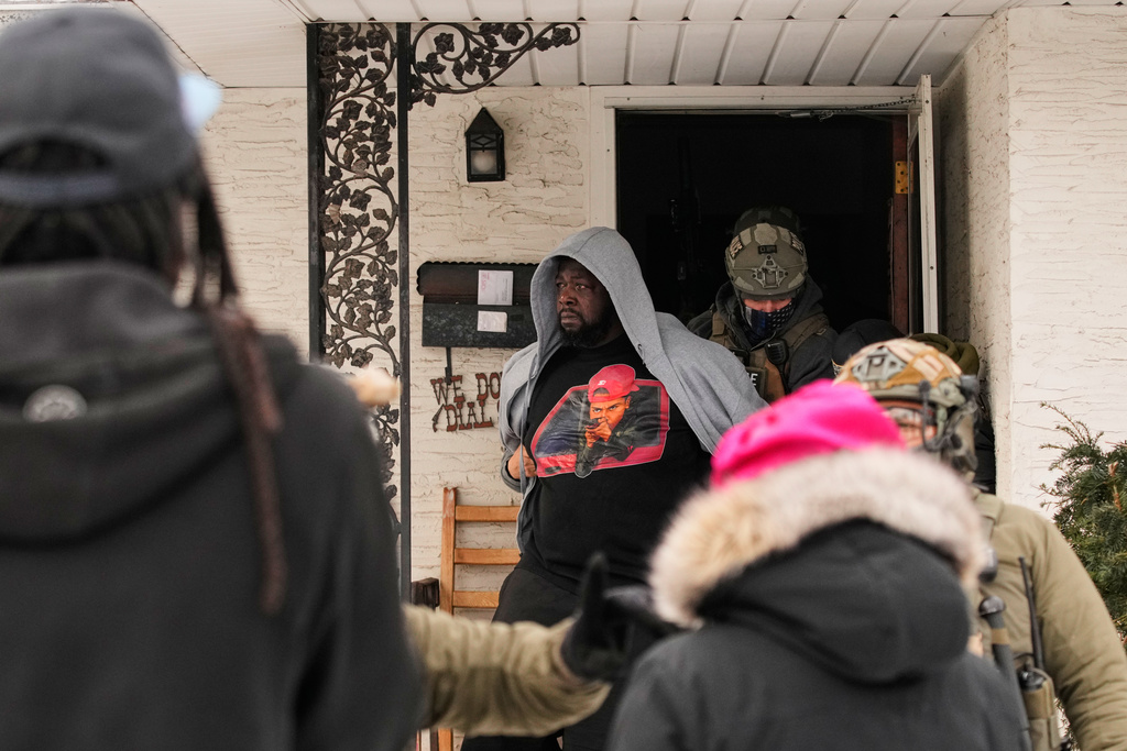 ADDS IDENTIFICATION: Garrison Gibson is arrested by federal immigration officers Sunday, Jan. 11, 2026, in Minneapolis. (AP Photo/John Locher)