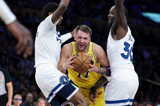 Los Angeles Lakers guard Luka Doncic, center, drives against Minnesota Timberwolves forward Jaden McDaniels, left, and forward Julius Randle during the first half of an NBA basketball game, Friday, Oct. 24, 2025, in Los Angeles. (AP Photo/Jessie Alcheh) Los Angeles Lakers guard Luka Doncic, center, drives against Minnesota Timberwolves forward Jaden McDaniels, left, and forward Julius Randle during the first half of an NBA basketball game, Friday, Oct. 24, 2025, in Los Angeles. (AP Photo/Jessie Alcheh)