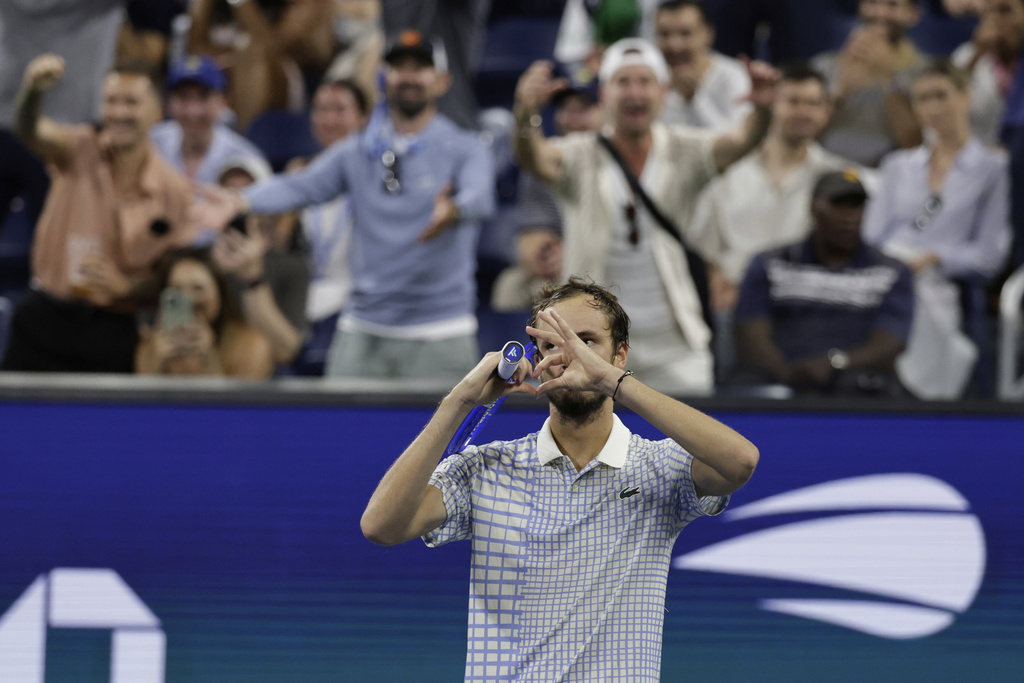 Fans react as Daniil Medvedev, of Russia, gestures after a photographer ran onto the court during a match against Benjamin Bonzi, of France, in the first-round of the U.S. Open tennis championships, Sunday, Aug. 24, 2025, in New York. (AP Photo/Adam Hunger)
