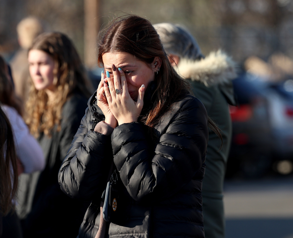 A woman reacts near the Lynch Arena in Pawtucket, R.I., after a shooting at the ice rink, Monday, Feb. 16, 2026. (AP Photo/Mark Stockwell)
