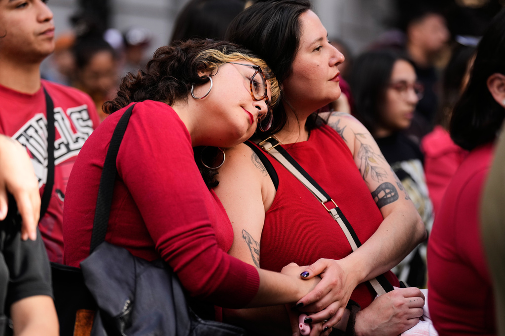 Supporters react to preliminary results at the campaign headquarters of Jeannette Jara, presidential candidate of the ruling Unity for Chile coalition, after polls closed for the presidential runoff in Santiago, Chile, Sunday, Dec. 14, 2025.. (AP Photo/Natacha Pisarenko)