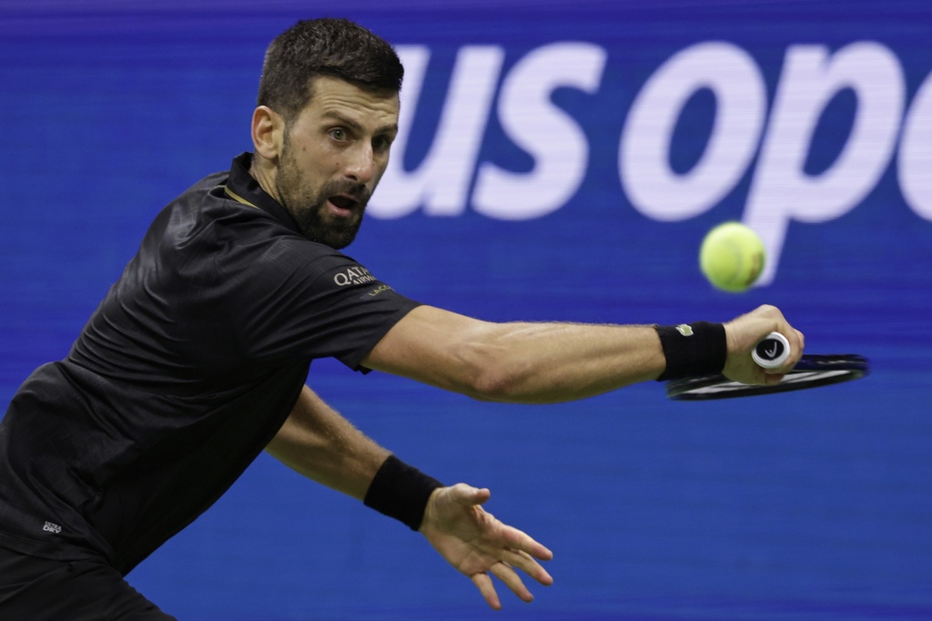 Novak Djokovic, of Serbia, returns a shot against Taylor Fritz, of the United States, during the quarterfinal round of the U.S. Open tennis championships, Tuesday, Sept. 2, 2025, in New York. (AP Photo/Adam Hunger)