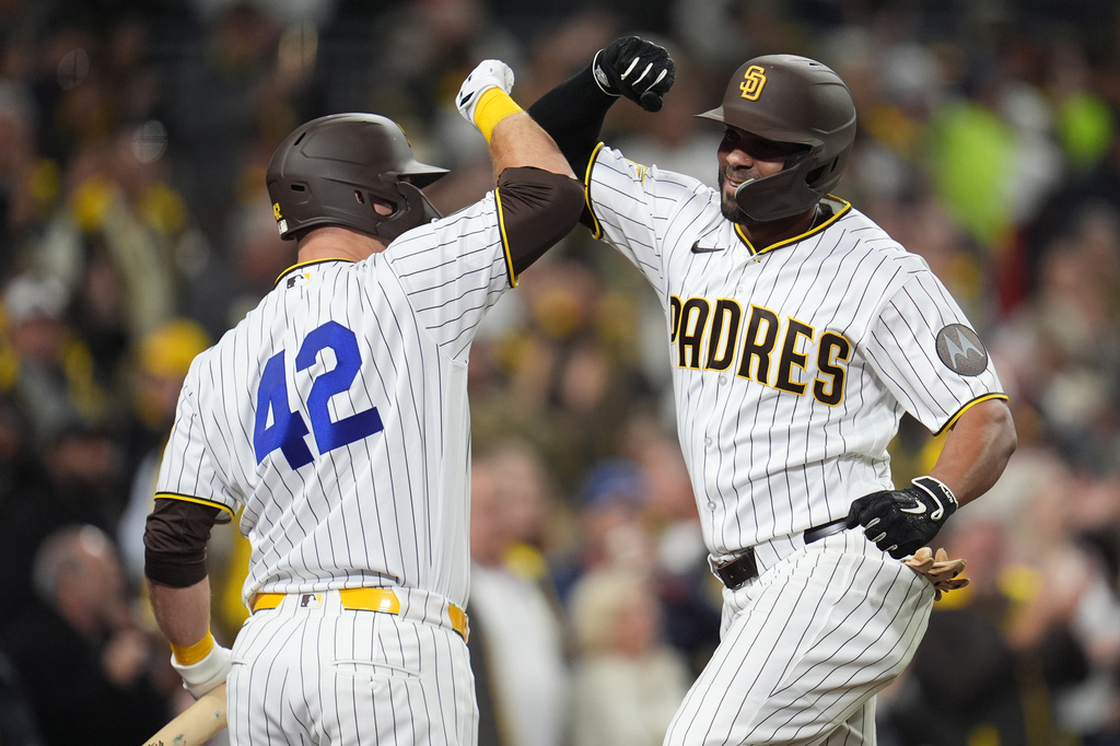 San Diego Padres' Xander Bogaerts, right, celebrates his two-run home run with teammate Gavin Sheets during the sixth inning of a baseball game against the Seattle Mariners Wednesday, April 15, 2026, in San Diego. (AP Photo/Gregory Bull)