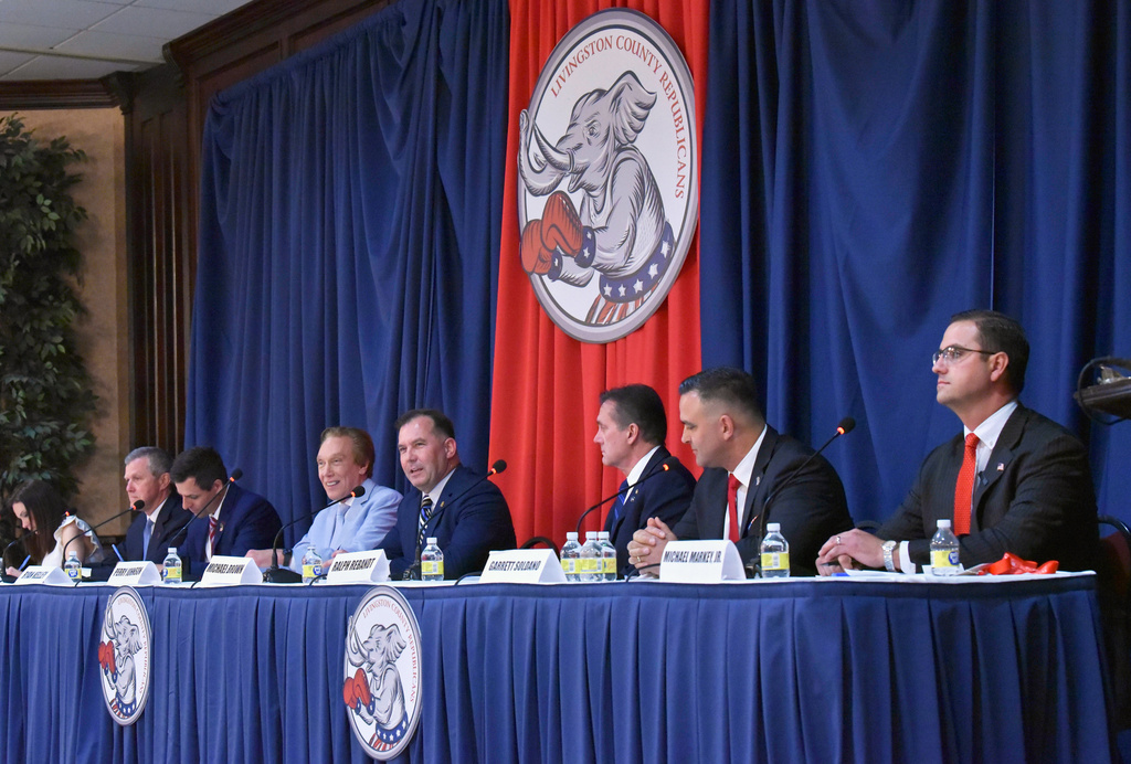 FILE - Candidates, from left, Tudor Dixon, Kevin Rinke, Ryan Kelley, Perry Johnson, Michael Brown, Ralph Rebandt, Garrett Soldano and Michael Markey participate in the Livingston County Republican Party GOP Gubernatorial debate in Howell, Mich., on May 12, 2022. (Todd McInturf/Detroit News via AP, File)