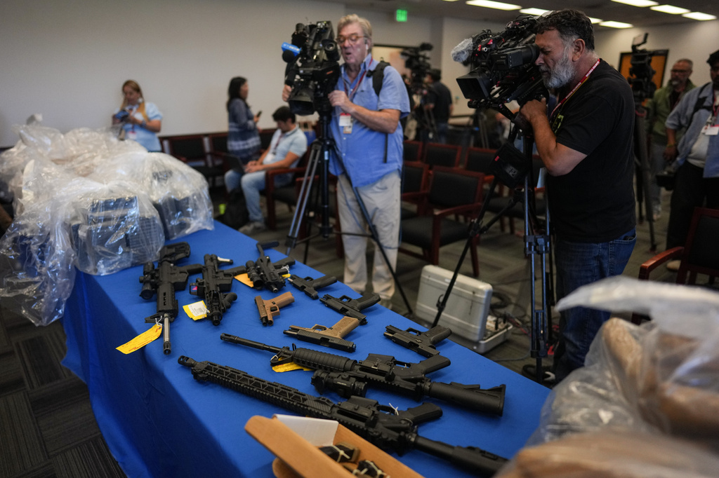 Seized evidence including firearms and drugs, is displayed at a news conference at the Federal Building in Los Angeles, Tuesday, July 7, 2026. (AP Photo/Jae C. Hong)