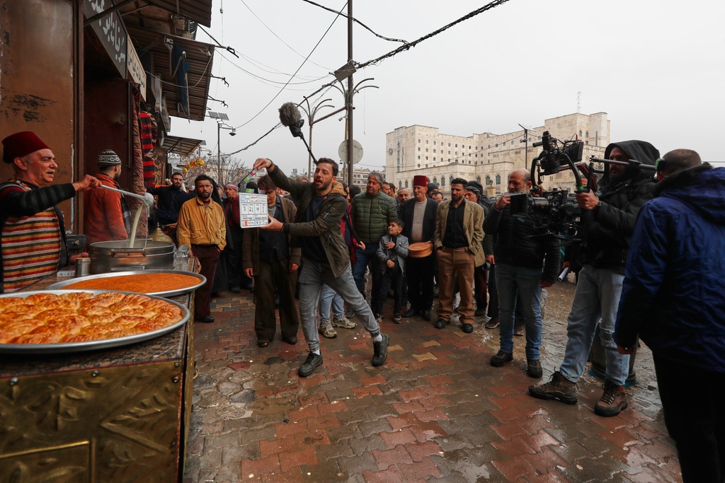 A television crew films an episode of the TV series "Al-Souriyoun al-Aada" ("The Syrian Enemies"), based on a novel of the same name that was banned under Bashar Assad, along a transformed street in central Aleppo, Syria, Friday, Feb. 13, 2026.(AP Photo/Omar Sanadiki)