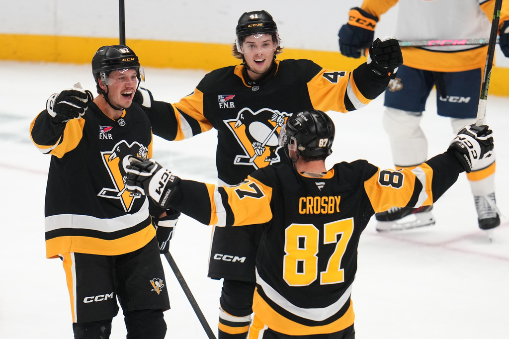 Pittsburgh Penguins' Rickard Rakell (67) celebrates after his goal with Ville Koivunen (41) and Sidney Crosby (87) during the third period of an NHL hockey game against the Nashville Predators in Pittsburgh, Saturday, Oct. 24, 2026. (AP Photo/Gene J. Puskar)