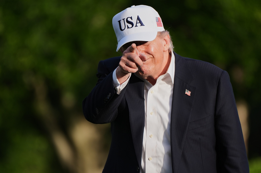 President Donald Trump gestures to reporters as he walks across the South Lawn of the White House, Friday, May 15, 2026, in Washington, on return from Beijing where he met with China's President Xi Jinping. (AP Photo/Jacquelyn Martin)