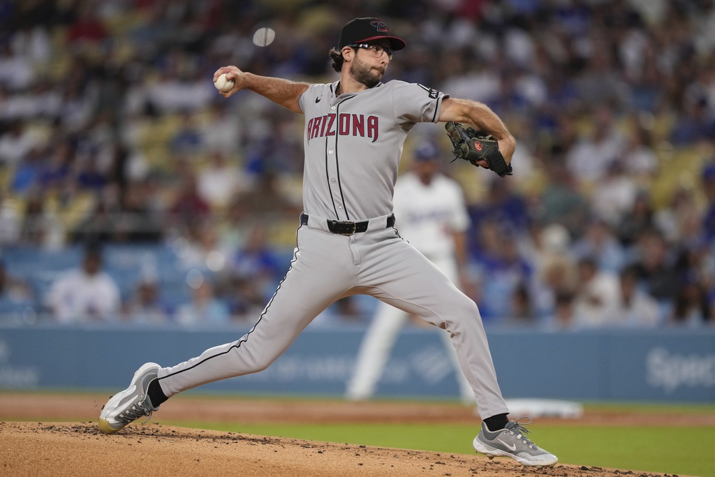 Arizona Diamondbacks starting pitcher Zac Gallen throws to the plate during the first inning of a baseball game against the Los Angeles Dodgers, Friday, Aug. 29, 2025, in Los Angeles. (AP Photo/Mark J. Terrill)