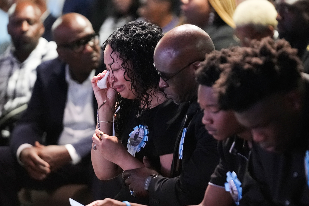 From left to right, Christine Wonsley cries next to her Husband Elmore, and their sons Elmore Jr. and Ethan during a memorial service for her son Nolan Xavier Wells, an 18-year-old found dead after taking a July 4 boat trip with friends, Monday, July 20, 2026, in Ocean Springs, Miss. (AP Photo/Gerald Herbert)