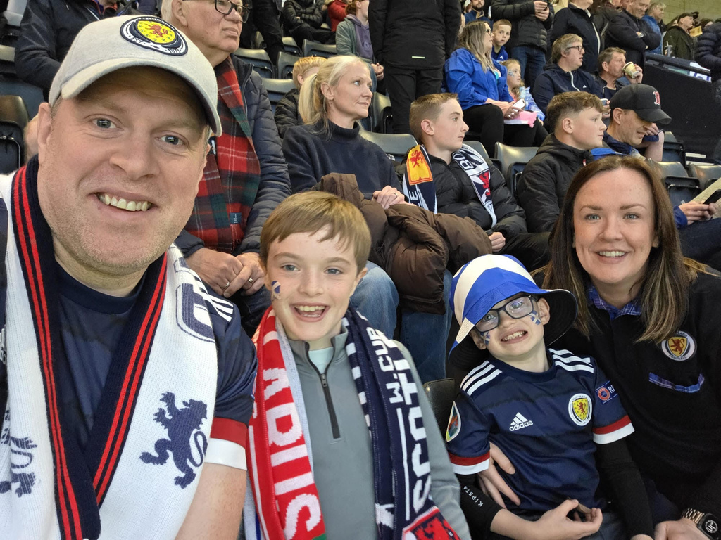 In this selfie provided by Campbell Lewis, Campbell Lewis and his family attend a World Cup qualifying soccer match between Scotland and Belarus at Hampden Park in Glasgow, Scotland, Sunday, Oct. 12, 2025. (Campbell Lewis via AP)