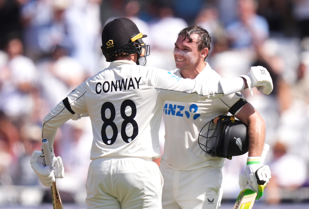 New Zealand's Tom Latham, right, celebrates reaching a century, during day one of the Third Test cricket match between England and New Zealand, in Nottingham, England, Thursday June 25, 2026. (Mike Egerton/PA via AP)