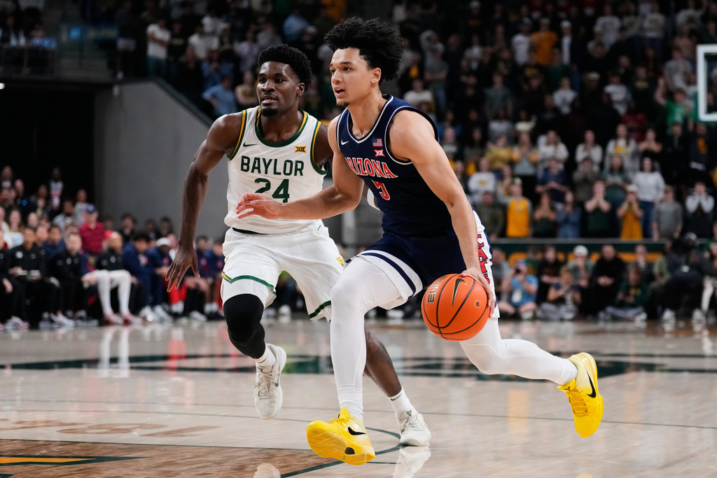 Arizona guard Brayden Burries (5) drives to the basket as Baylor's Tounde Yessoufou (24) defends first half of an NCAA college basketball game in Waco, Texas, Tuesday, Feb. 24, 2026. (AP Photo/Tony Gutierrez)