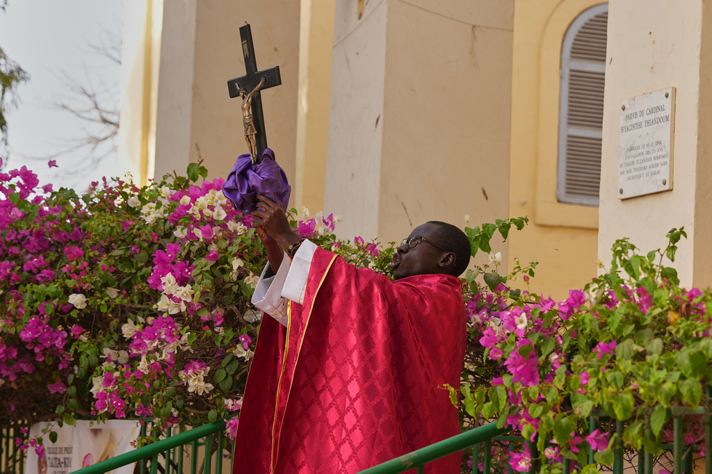 A priest celebrates a service marking Good Friday at the Saint Charles church on Goree Island, Senegal, Friday, April 3, 2026. (AP Photo/Misper Apawu)