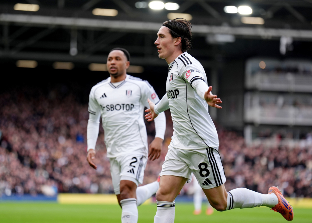Fulham's Harry Wilson, right, celebrates after scoring his sides first goal during the English Premier League soccer match between Fulham and Tottenham in London, Sunday, March 1, 2026. (John Walton/PA via AP)